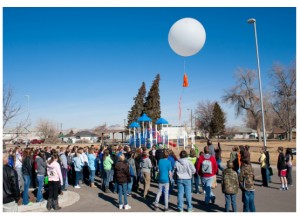 Vernal Middle School students watching a demonstration of air study monitoring ballown.